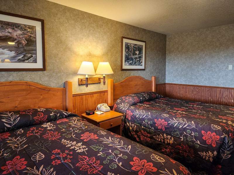 Hotel room with two beds with floral bedspreads