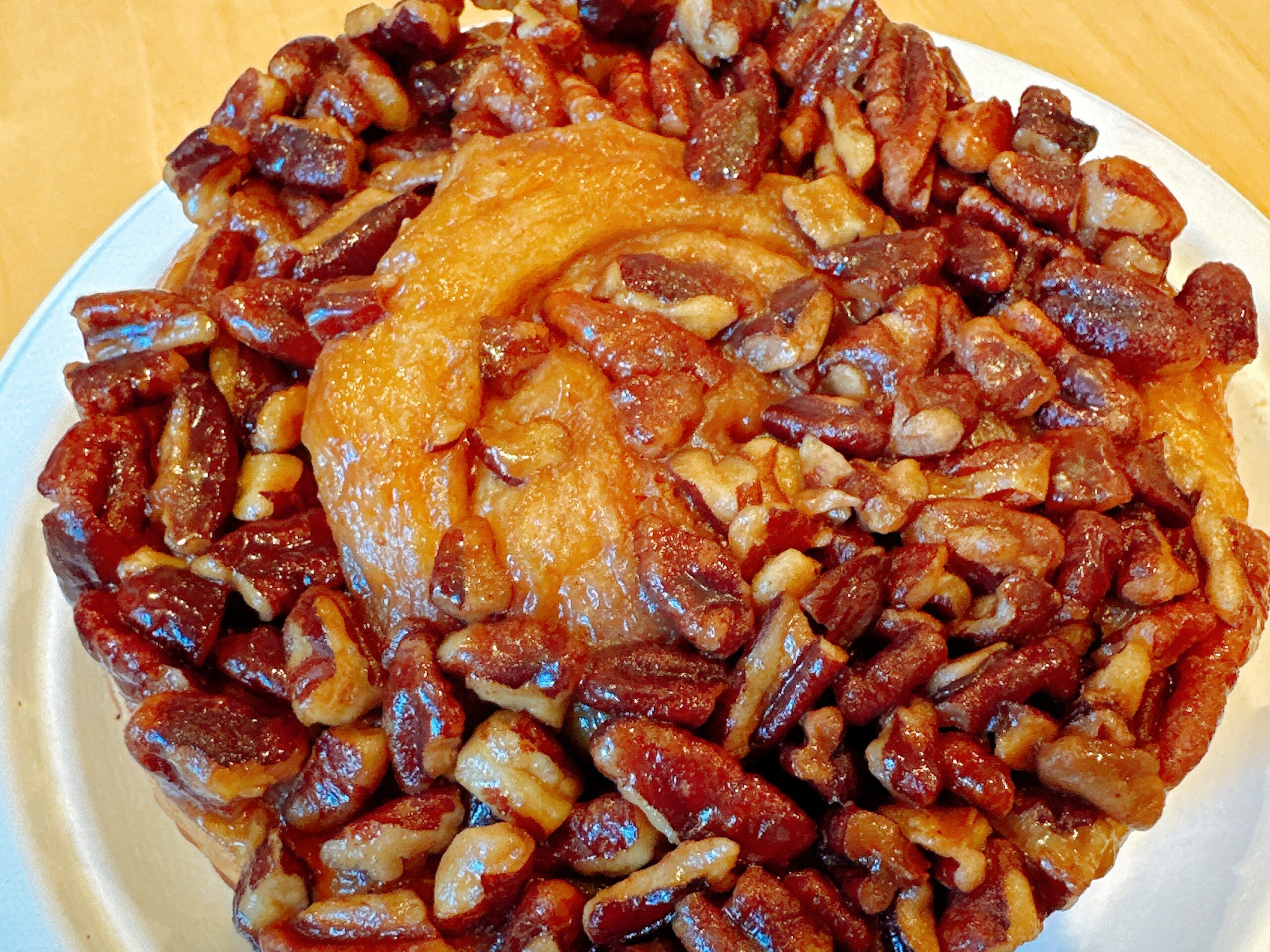 Sticky Bun with nuts at the d'Andrews Bakery & Cafe. Photo credit: Robin O'Neal Smith A sticky bun pastry with nuts on a plate at d'Andrews Bakery & Cafe.