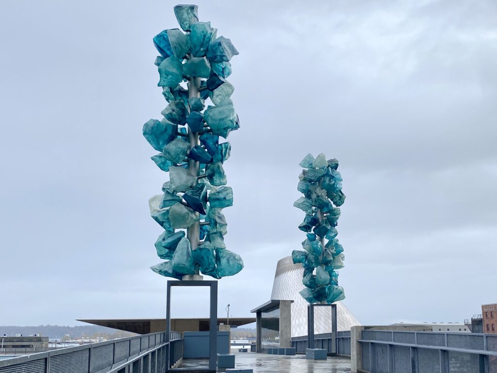 Blue Crystal Towers art created by Dale Chihuly set outdoors on a bridge