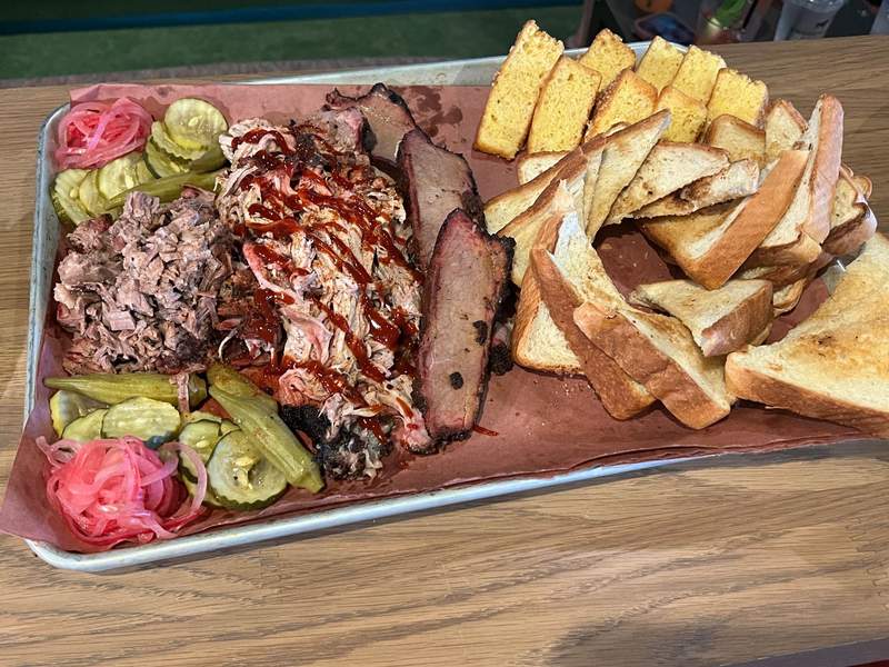 BBQ platter with a variety of meats and bread.