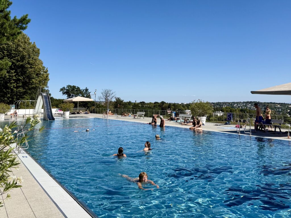 Opelbad swimming pool with slide and panoramic view of Wiesbaden, Germany