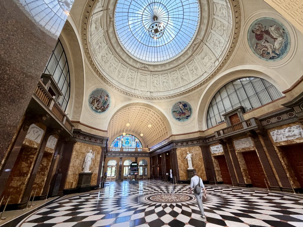 Elegant foyer of the casino in Wiesbaden with domed ceiling geometric tile floors and statuary.