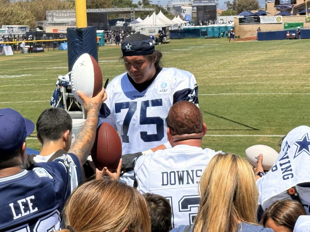 Dallas Cowboy player signing autographs at Oxnard, CA training camp