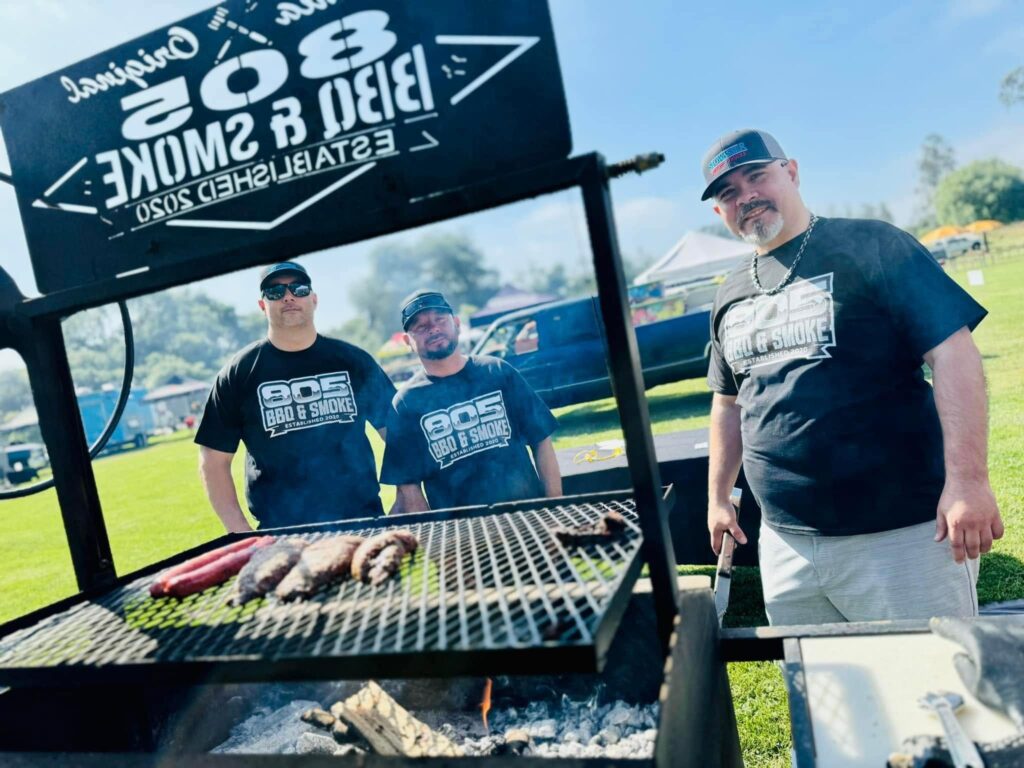 3 competitors from the 805 BBQ & Smokehouse team next to their grilled meats