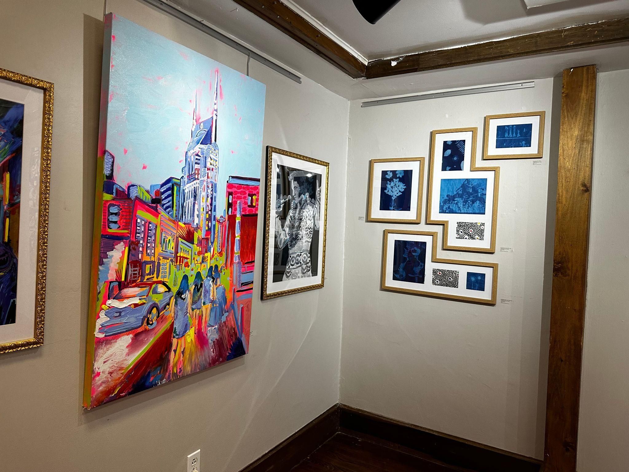 Paintings and artwork on a wall.