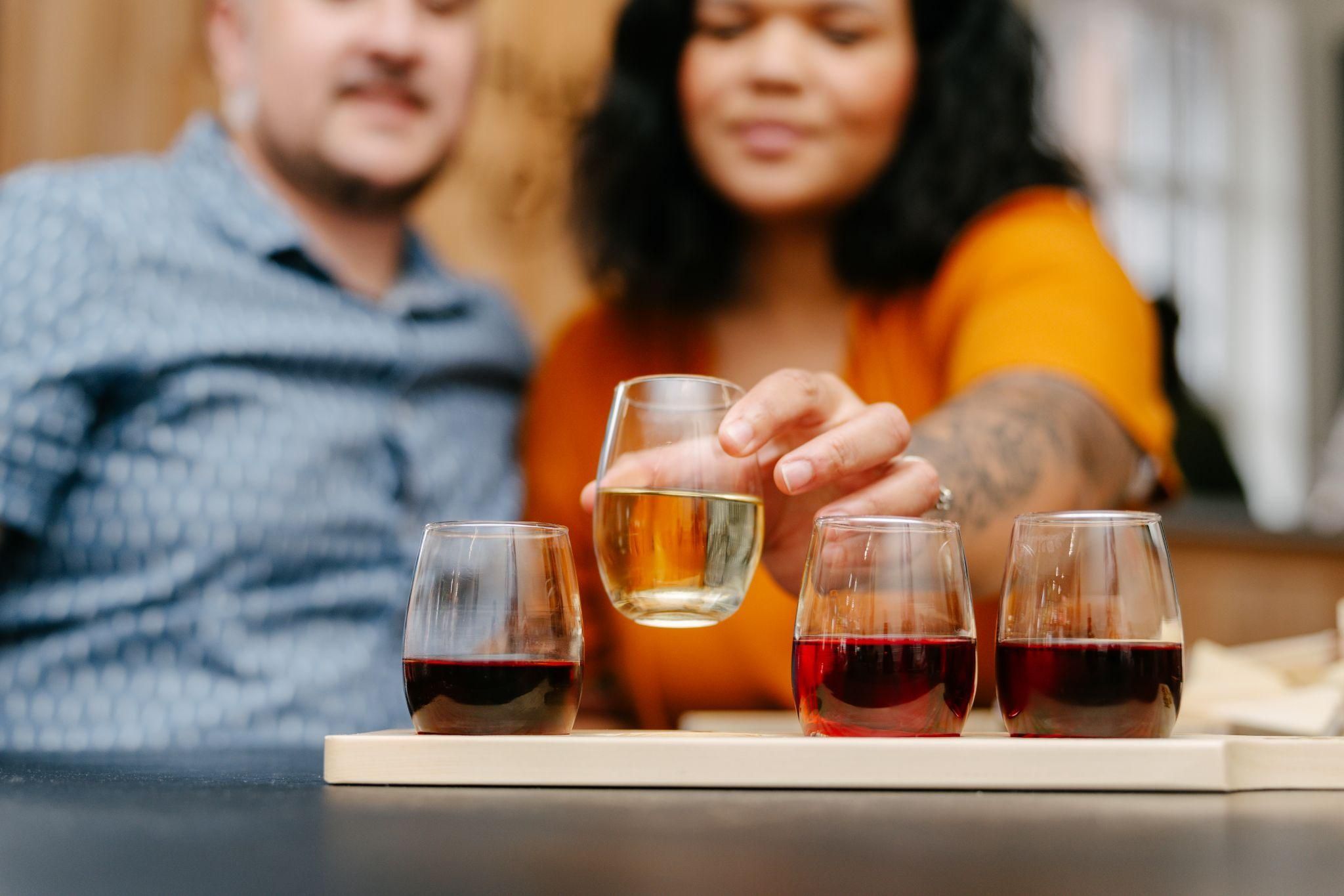 Two people and a flight of wine.