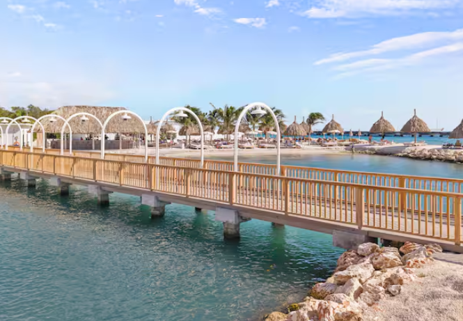 An over-water walkway at The Rif at Mangrove Beach Corendon Curacao, a Hilton all-inclusive resort