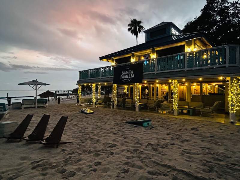 On the beach is the two-story SkyBar + Grille, with sparkling lights shining during sunset