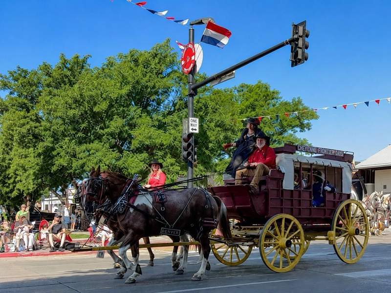 Historic covered wagon traveling through downtown Cheyenne during the Cheyenne Frontier Days Grand Parade.
