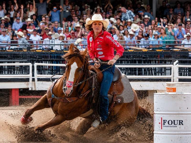 Cowgirl barrel racer on horseback making a tight turn around a barrel at Cheyenne Frontier Days.