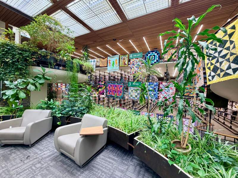 A reading nook with comfortable chairs and plants surrounding the space at the Downtown Reno Library.