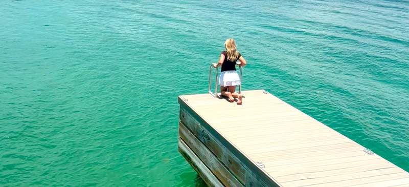 Girl standing on a private villa dock at South Bank Resort in Turks and Caicos.