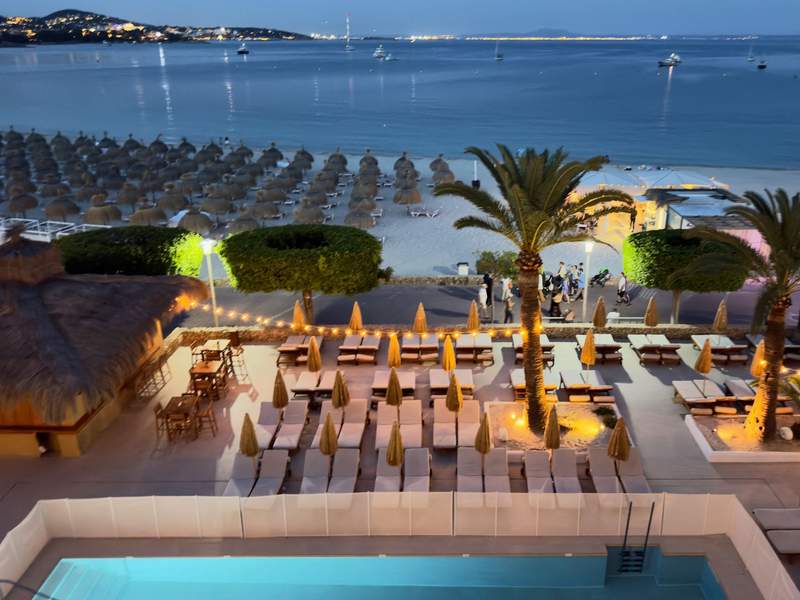 Evening view of the ZEL Mallorca pool terrace, Palmanova Beach and boats on the Mediterranean