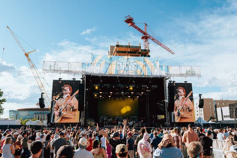 Crowds gather in front of a large stage at Outside Days. Photo credit: Baeth / Visit Denver