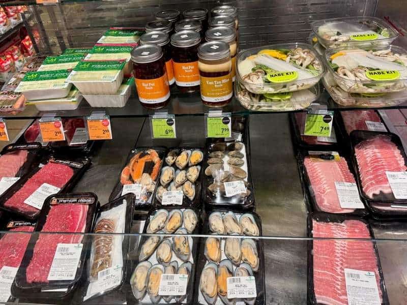 Foodland’s refrigerated case is packed with thinly sliced beef and pork, tofu, shellfish, mushrooms, vegetables and ready-to-cook nabe kits.