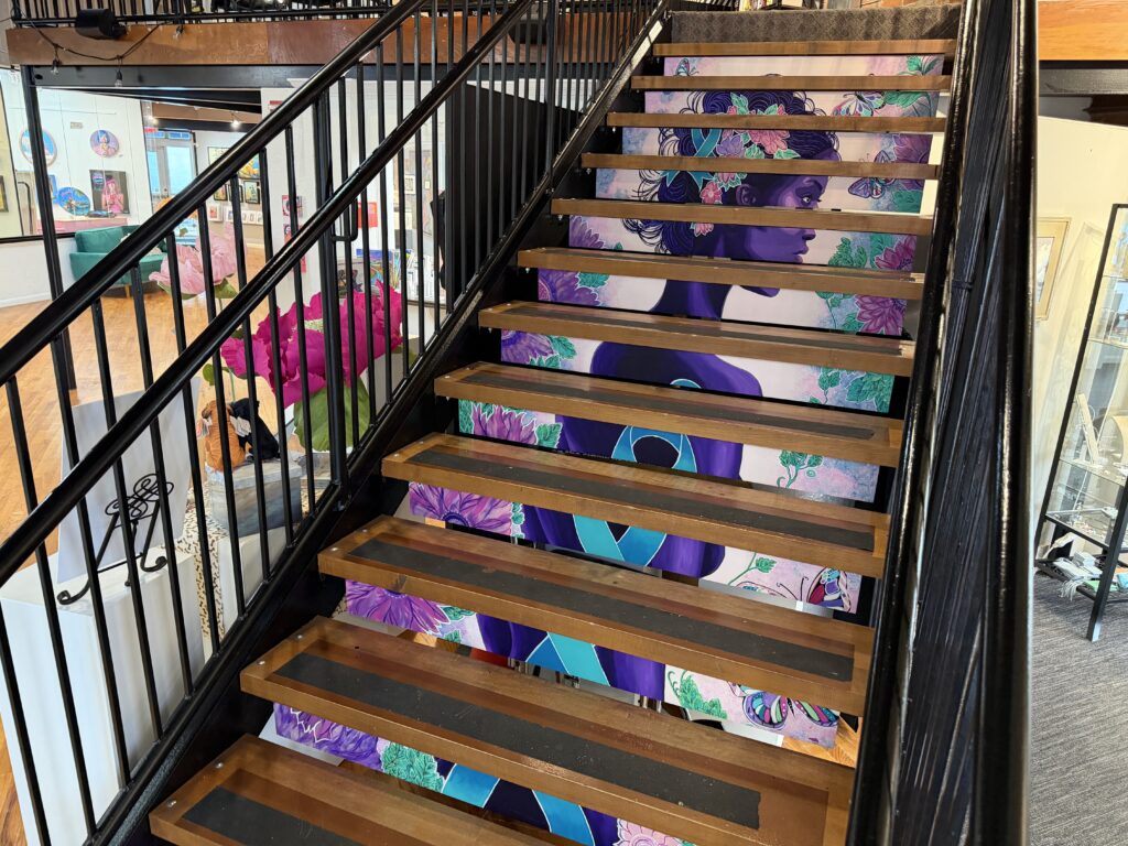 stair treads painted with the image of a woman, an arts project at the HUB arts collective in new smyrna beach