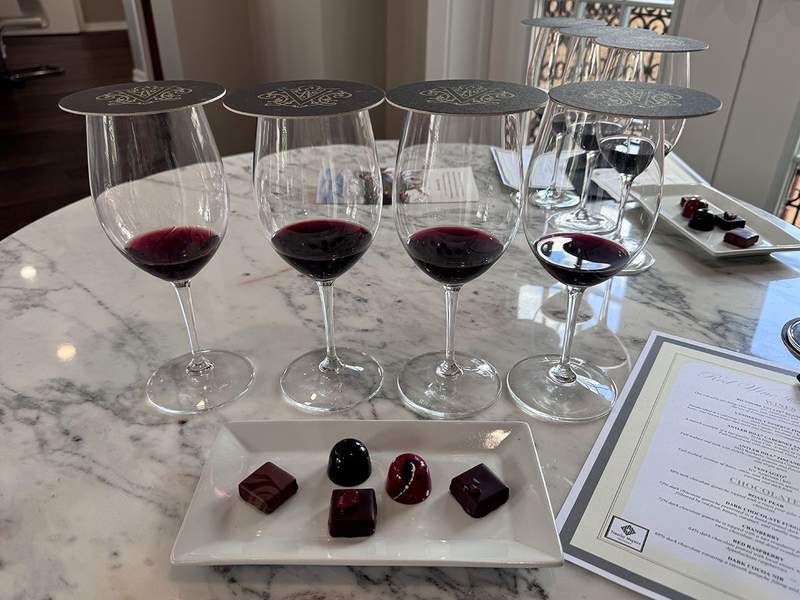 Red wine and chocolate tasting with glasses of wine and chocolate pairings arranged on a table