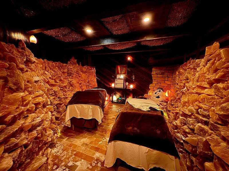 A salt cave set up with two massage tables for couples