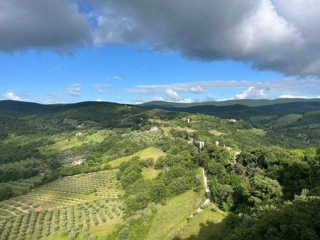 Stormy clouds hanging over the rolling hills of Umbria Italy with vineyards on the hillsides