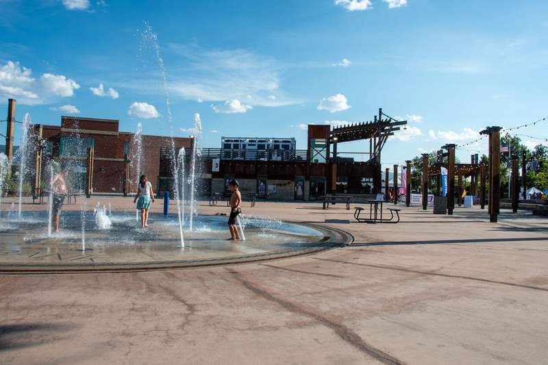 Kids enjoying the splash pad at the Davis Street Station. Photo credit: Phylicia Stitzel