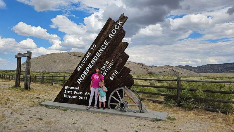 My kids standing in front of Independence Rock sign after an “Easter egg hunt” for the names carved into the rock. Photo credit: Phylicia Stitzel