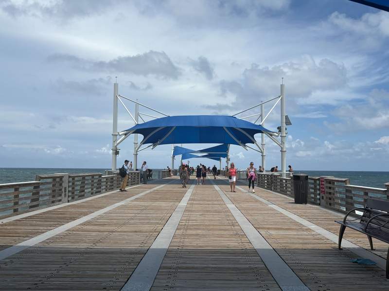 People walk along a pier in Fort Lauderdale.