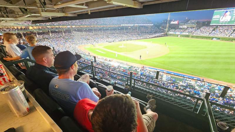 Several generations of family members enjoying the tradition of attending a baseball game at Wrigley Field.
