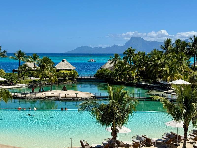 View of swimming pool, private lagoon, and beachfront rooms at InterContinental Tahiti Resort & Spa