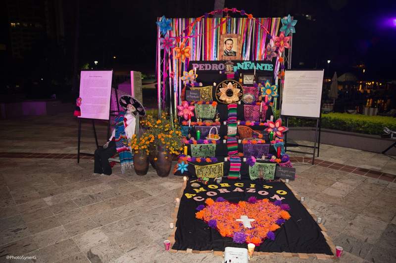 Colorful Dia de los Muertos altar decorated with marigolds, candles and offerings at Marriott Puerto Vallarta Resort & Spa.