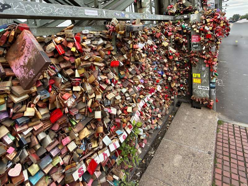 Thousands of colorful locks attached to a bridge.