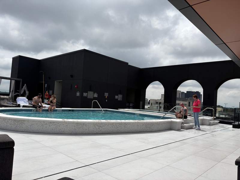 pool deck with guests and downtown skyline in background