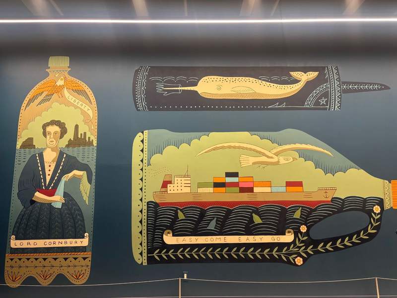 A wall mural featuring stylized illustrations inside bottle shapes