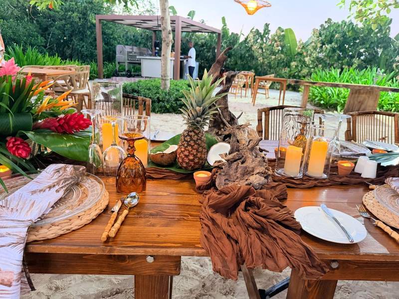 Private beach dining setup at Princess Senses The Mangrove in Jamaica featuring tropical table décor, fresh flowers, candles, and an outdoor chef-prepared dinner experience.