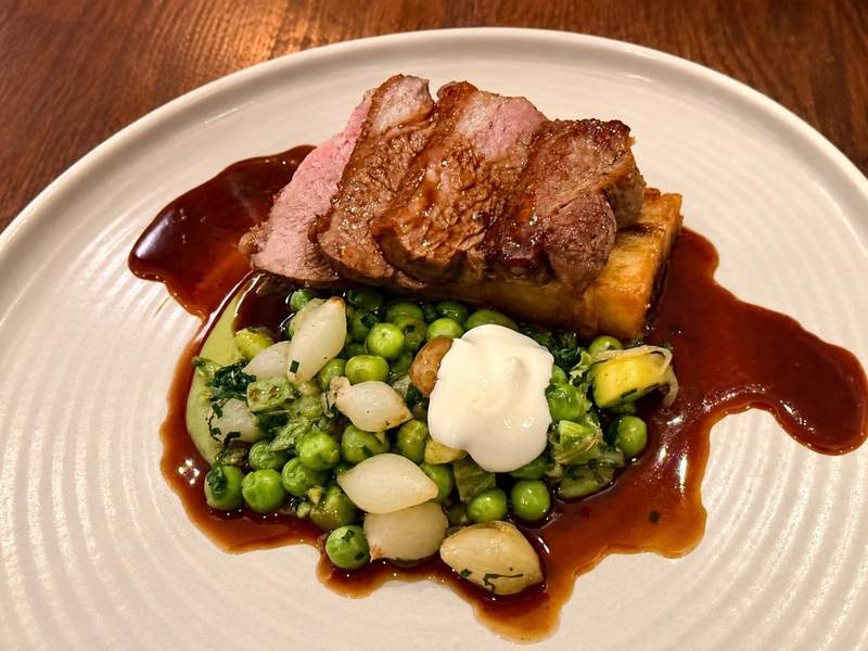 Welsh lamb rump with potato terrine peas baby onions and whipped goat curd