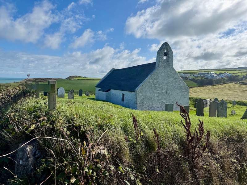  Church of the Holy Cross surrounded by green hills at Mwnt Wales