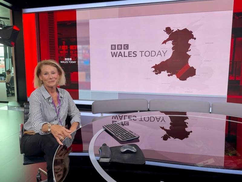  Sharon Kurtz seated at a BBC Cymru Wales news desk in Cardiff