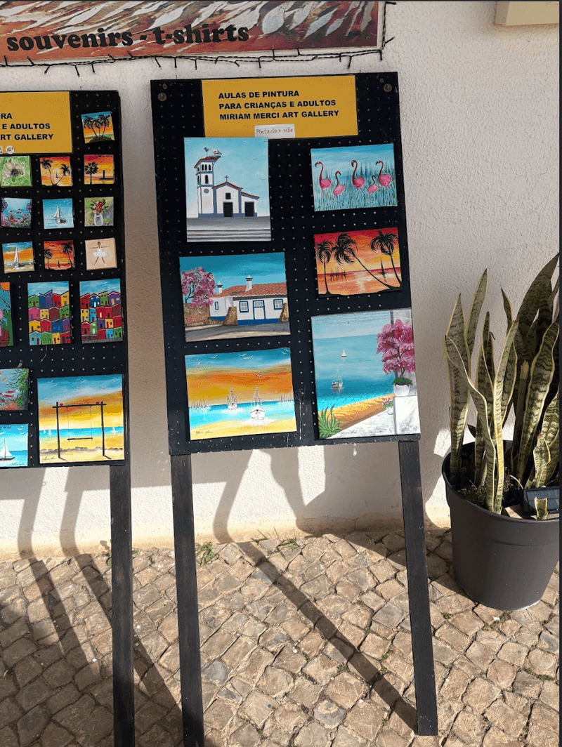Art studio displaying colorful original paintings on canvas