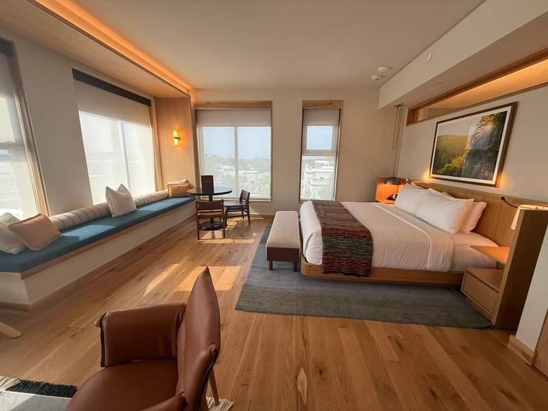 Rooms and suites at The Compton in Bentonville feature comfortable beds, wood floors and bench window seating in with lots of light.