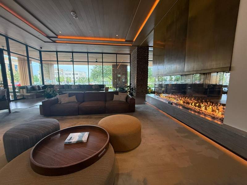 The spacious lobby of The Compton in Bentonville features a warm fireplace and a cycling concierge desk to answer questions about area trails and bike rentals along with ample seating for groups to gather.