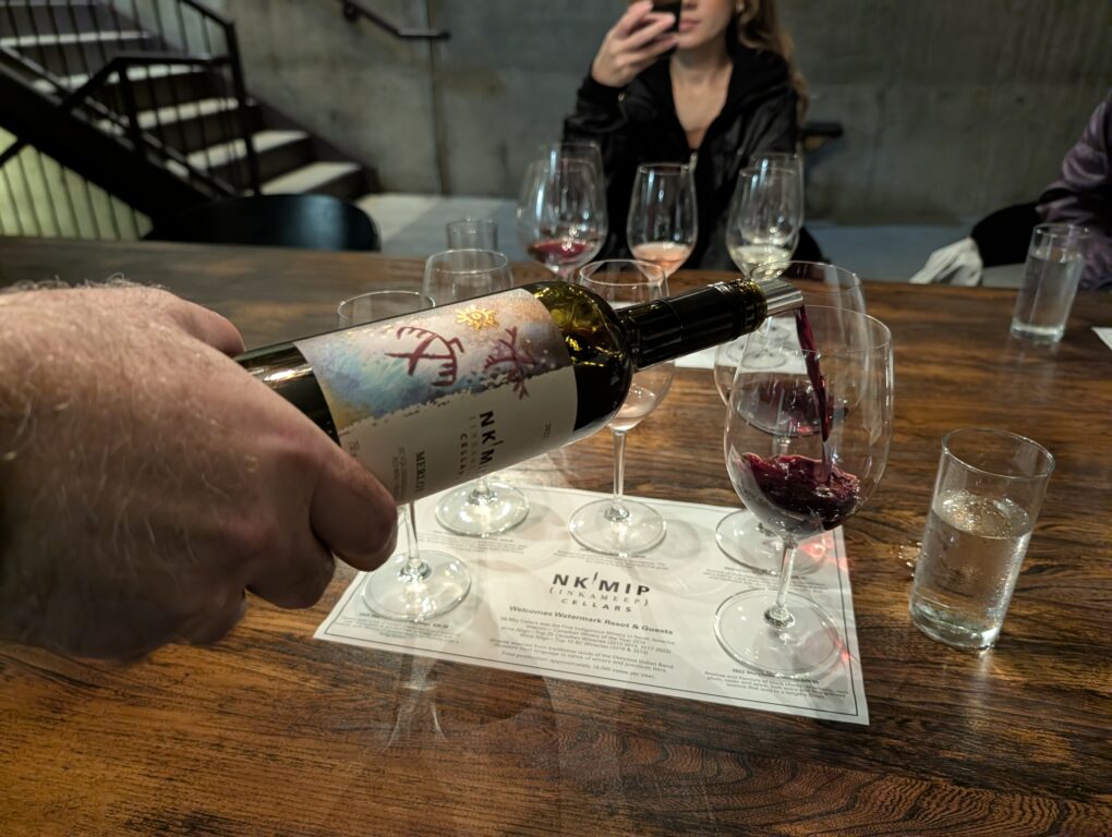 man's hand pouring a glass of wine at a wine tasting at the Nk'Mip wintery in Canada's Osoyoos wine region