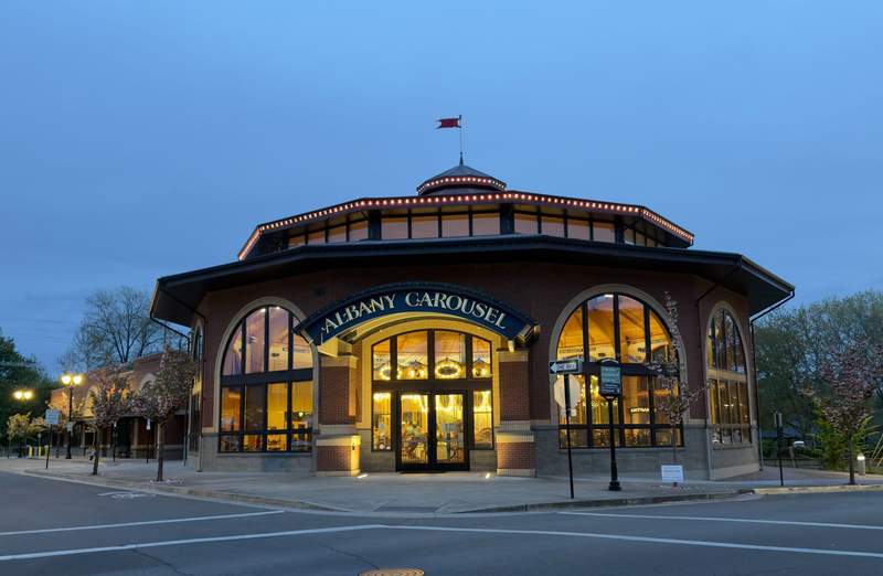 Illuminated Albany Historic Carousel and Museum building at dusk in downtown Albany Oregon