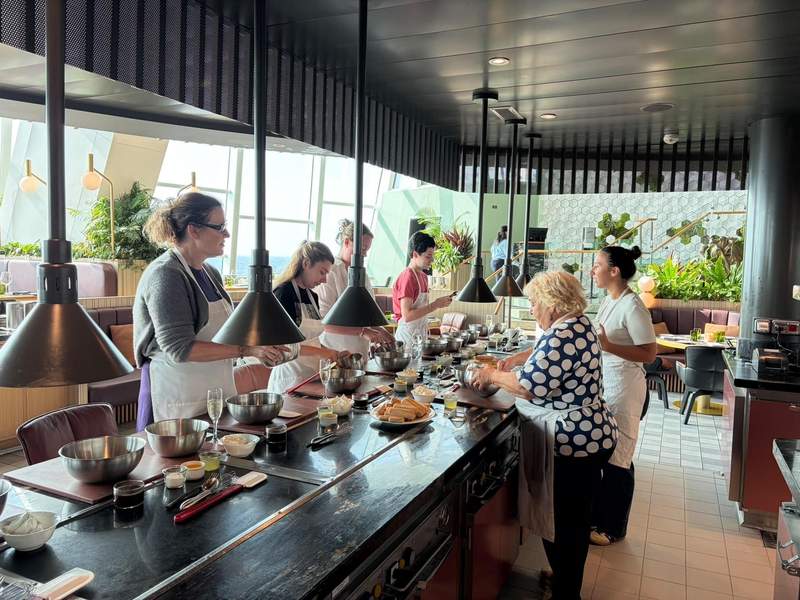 Cruise passengers taking a cooking class aboard Celebrity Ascent