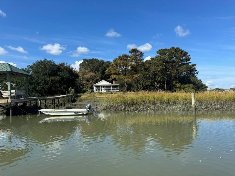 Captain navigating a boat tour through coastal Lowcountry marshes near Bowens Island