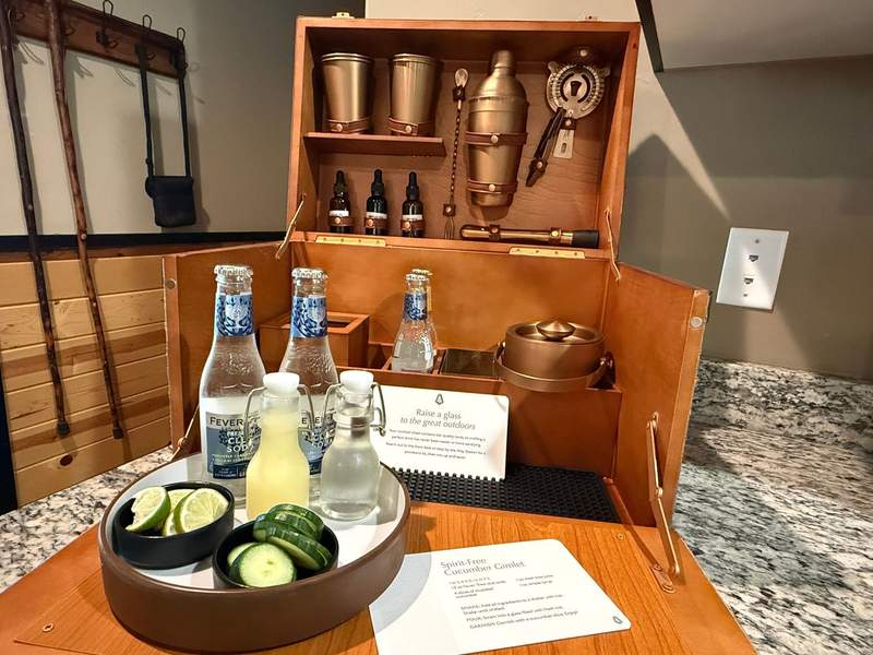 A wood cocktail chest with cucumber gimlet drink supplies at Waybound Yosemite.