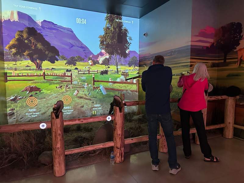 Two people shotting at the targets at the Theodore Roosevelt Presidential Library.