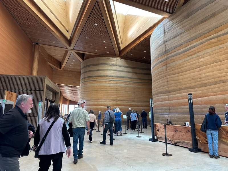 The lobby of the Theodore Roosevelt Presidential Library. It is made of stone and wood resembling the badlands.