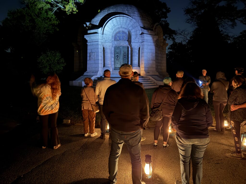 Evening in Sleepy Hollow cemetery with people and kerosene lanterns