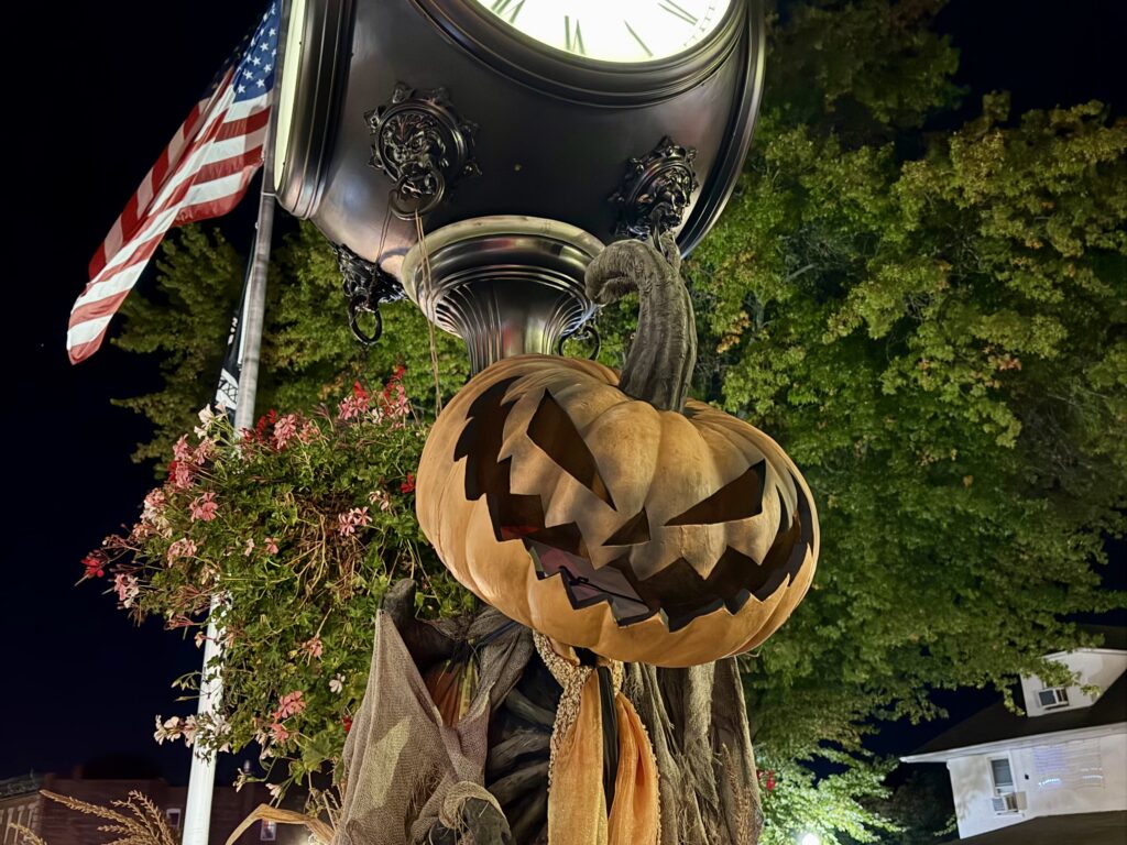 Jack O Lantern in front of Sleepy Hollow village clock