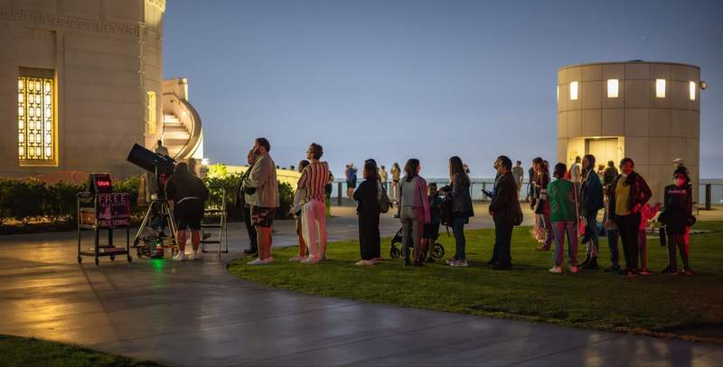 Visitors lined up at dusk on the Griffith Observatory lawn for a free public telescope pointed at Saturn